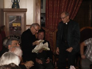 Msgr. Sako receives the cross from Rob Weingartner of The Outreach Foundation in Kirkuk, Iraq, November, 2012.